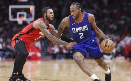Mar 6, 2024; Houston, Texas, USA; Los Angeles Clippers forward Kawhi Leonard (2) drives with the ball as Houston Rockets forward Cam Whitmore (7) defends during the fourth quarter at Toyota Center. Mandatory Credit: Troy Taormina-USA TODAY Sports