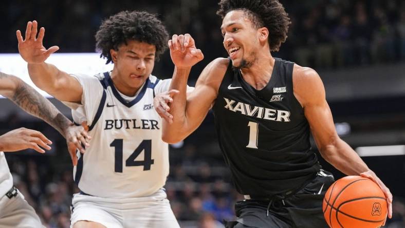 Xavier Musketeers guard Desmond Claude (1) rushes past Butler Bulldogs guard Landon Moore (14) on Wednesday, March 6, 2024, during the game at Hinkle Fieldhouse in Indianapolis. The Butler Bulldogs defeated the Xavier Musketeers, 72-66.