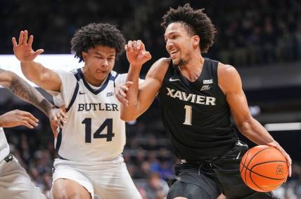 Xavier Musketeers guard Desmond Claude (1) rushes past Butler Bulldogs guard Landon Moore (14) on Wednesday, March 6, 2024, during the game at Hinkle Fieldhouse in Indianapolis. The Butler Bulldogs defeated the Xavier Musketeers, 72-66.