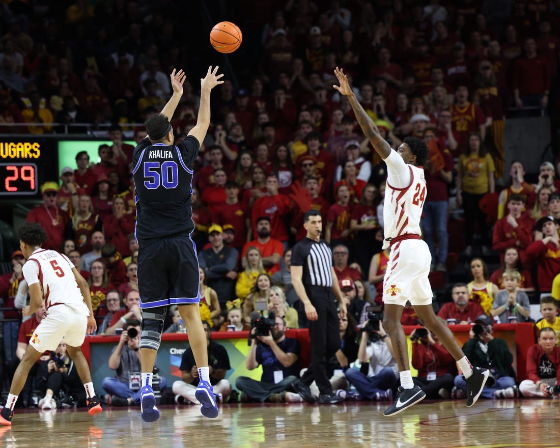 Mar 6, 2024; Ames, Iowa, USA;  Brigham Young Cougars center Aly Khalifa (50) shoots over Iowa State Cyclones forward Hason Ward (24) at James H. Hilton Coliseum. Mandatory Credit: Reese Strickland-USA TODAY Sports