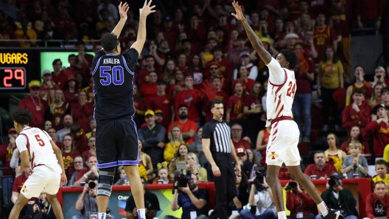 Mar 6, 2024; Ames, Iowa, USA;  Brigham Young Cougars center Aly Khalifa (50) shoots over Iowa State Cyclones forward Hason Ward (24) at James H. Hilton Coliseum. Mandatory Credit: Reese Strickland-USA TODAY Sports