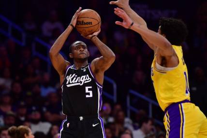 Mar 6, 2024; Los Angeles, California, USA; Sacramento Kings guard De'Aaron Fox (5) shoots against Los Angeles Lakers guard Max Christie (10) during the first half at Crypto.com Arena. Mandatory Credit: Gary A. Vasquez-USA TODAY Sports