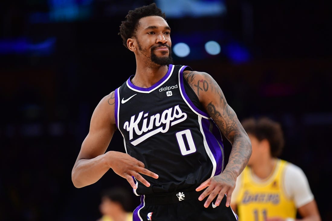 Mar 6, 2024; Los Angeles, California, USA;  Sacramento Kings guard Malik Monk (0) reacts after scoring a three point basket against the against the Los Angeles Lakers during the second half at Crypto.com Arena. Mandatory Credit: Gary A. Vasquez-USA TODAY Sports