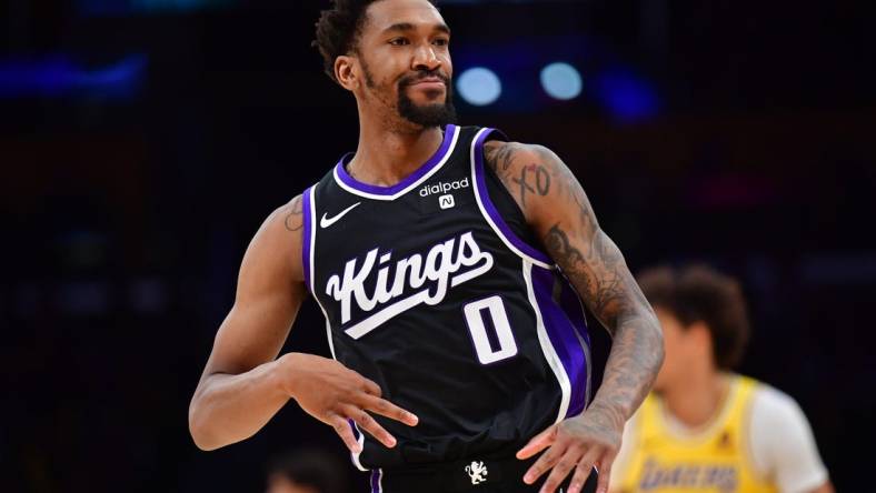 Mar 6, 2024; Los Angeles, California, USA;  Sacramento Kings guard Malik Monk (0) reacts after scoring a three point basket against the against the Los Angeles Lakers during the second half at Crypto.com Arena. Mandatory Credit: Gary A. Vasquez-USA TODAY Sports