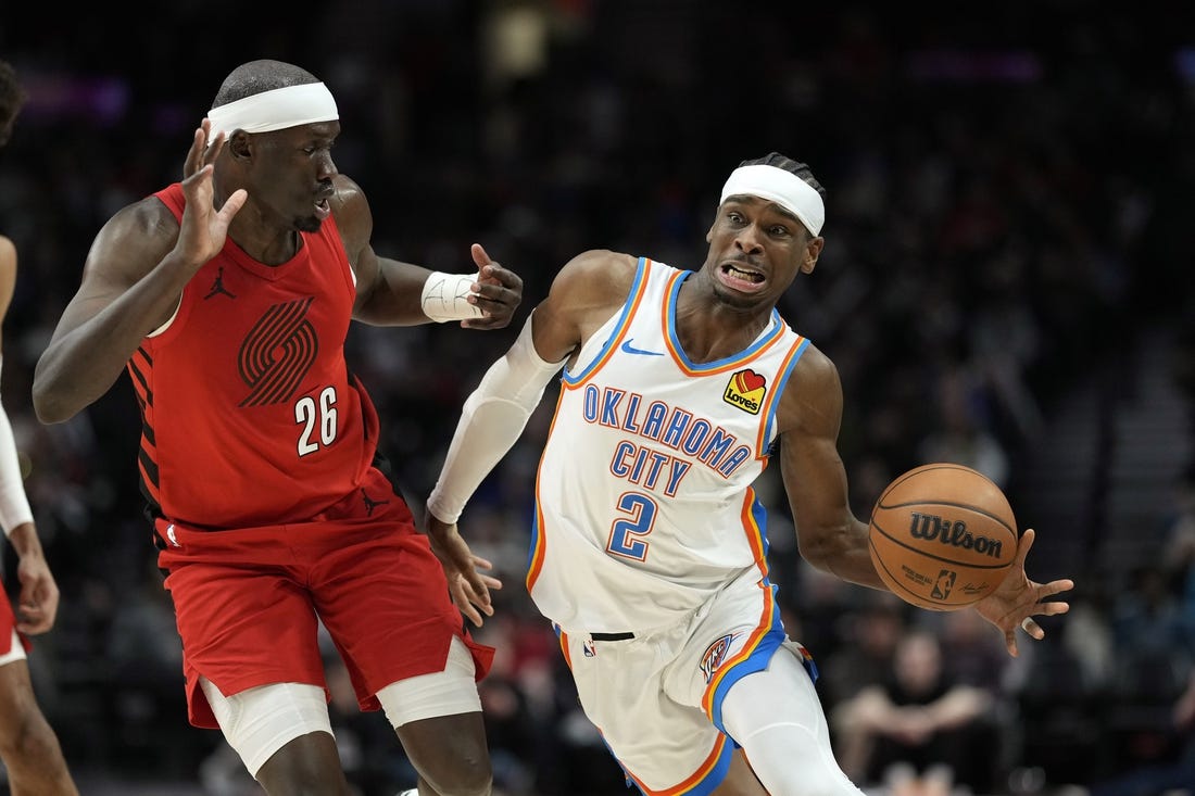 Mar 6, 2024; Portland, Oregon, USA; Oklahoma City Thunder point guard Shai Gilgeous-Alexander (2) is fouled by Portland Trail Blazers center Duop Reath (26) during the second half at Moda Center. Mandatory Credit: Soobum Im-USA TODAY Sports