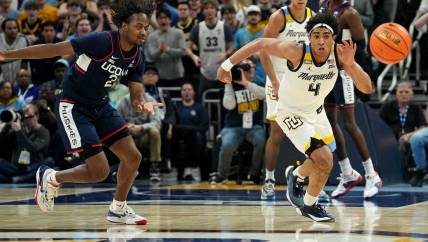 Marquette guard Stevie Mitchell (4) beats UConn guard Tristen Newton (2) to a loose ball during the first half of their game Wednesday, March 6, 2024 at Fiserv Forum in Milwaukee, Wisconsin.