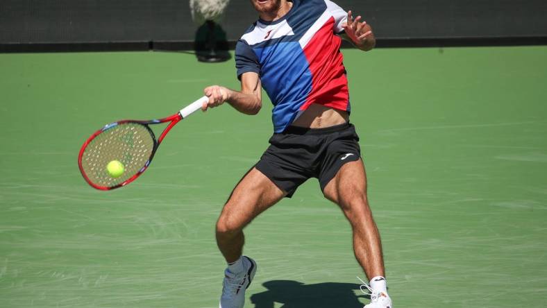 Tomas Machac hits a shot during his match against Stan Wawrinka on Stadium 1 at the BNP Paribas Open in Indian Wells, Calif., Mar. 7, 2024.