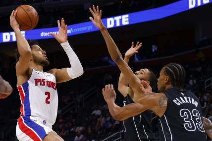 Mar 7, 2024; Detroit, Michigan, USA;  Detroit Pistons guard Cade Cunningham (2) shoots over Brooklyn Nets center Nic Claxton (33) in the first half at Little Caesars Arena. Mandatory Credit: Rick Osentoski-USA TODAY Sports