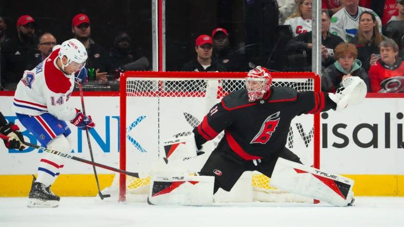 Mar 7, 2024; Raleigh, North Carolina, USA; Montreal Canadiens center Nick Suzuki (14) takes a shot on Carolina Hurricanes goaltender Frederik Andersen (31) during the first period at PNC Arena. Mandatory Credit: James Guillory-USA TODAY Sports