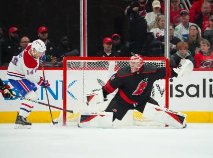 Mar 7, 2024; Raleigh, North Carolina, USA; Montreal Canadiens center Nick Suzuki (14) takes a shot on Carolina Hurricanes goaltender Frederik Andersen (31) during the first period at PNC Arena. Mandatory Credit: James Guillory-USA TODAY Sports