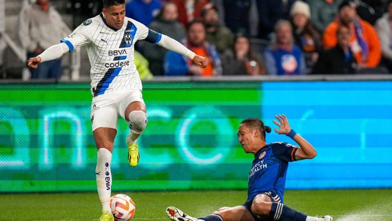 FC Cincinnati forward Yuya Kubo (7) slides under Monterrey midfielder Maximiliano Meza (11) in the first half of the CONCACAF Champions Cup Round of 16 game between the FC Cincinnati and the Monterrey at TQL Stadium in Cincinnati on Thursday, March 7, 2024. Monterrey led 1-0 at halftime.