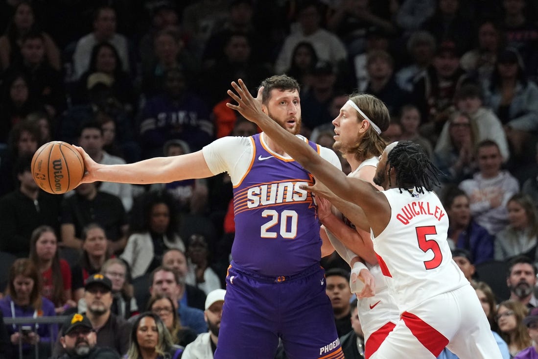 Mar 7, 2024; Phoenix, Arizona, USA; Phoenix Suns center Jusuf Nurkic (20) protects the ball from Toronto Raptors forward Kelly Olynyk (41) and Toronto Raptors guard Immanuel Quickley (5) during the first half at Footprint Center. Mandatory Credit: Joe Camporeale-USA TODAY Sports