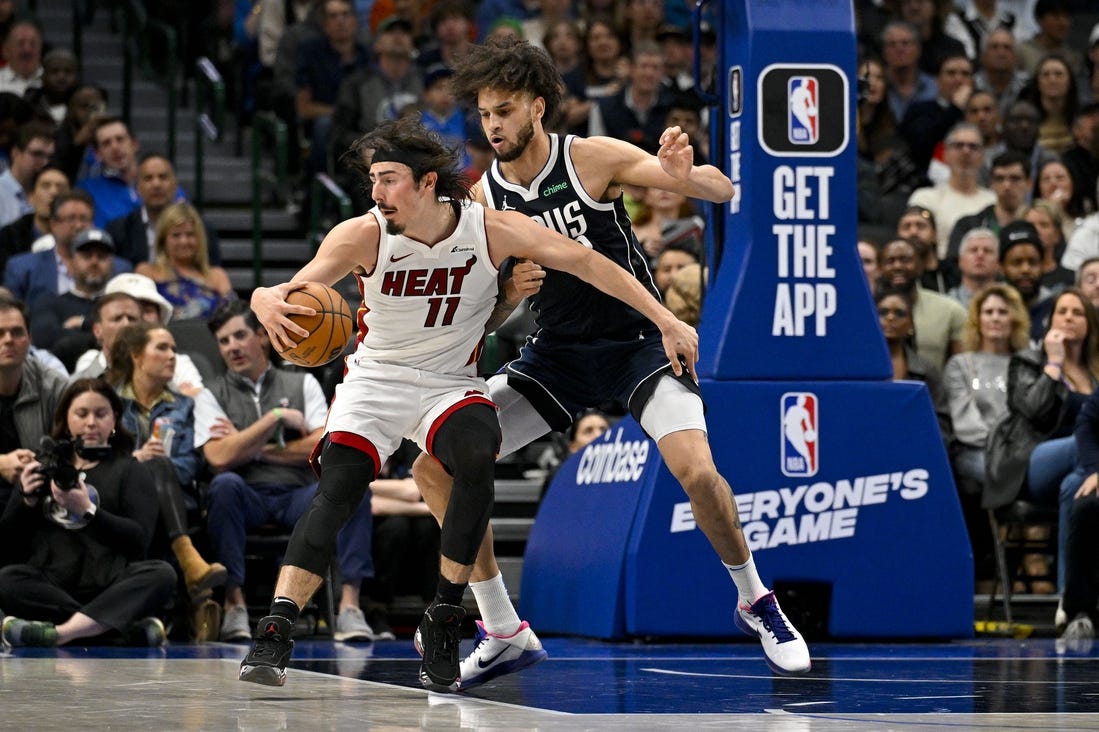 Mar 7, 2024; Dallas, Texas, USA; Miami Heat guard Jaime Jaquez Jr. (11) looks to move the ball past Dallas Mavericks center Dereck Lively II (2) during the second half at the American Airlines Center. Mandatory Credit: Jerome Miron-USA TODAY Sports