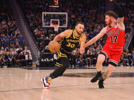 Mar 7, 2024; San Francisco, California, USA; Golden State Warriors guard Stephen Curry (30) drives in against against Chicago Bulls forward Onuralp Bitim (17) during the first quarter at Chase Center. Mandatory Credit: Kelley L Cox-USA TODAY Sports
