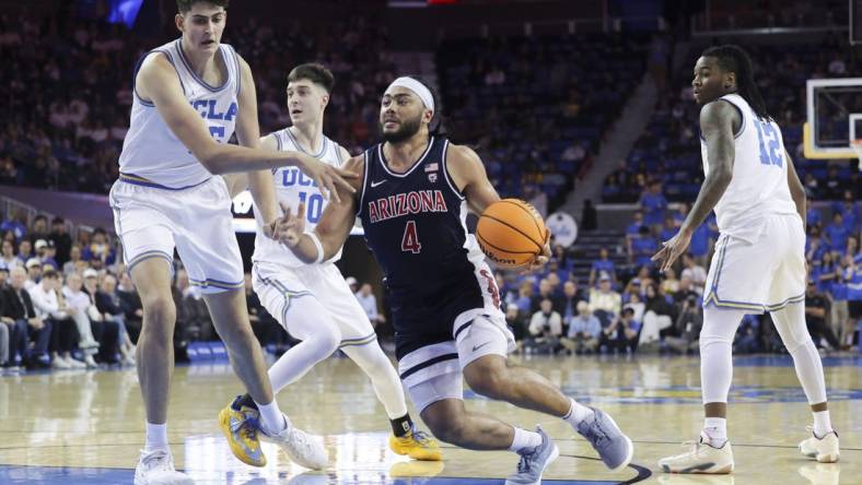 Mar 7, 2024; Los Angeles, California, USA; Arizona Wildcats guard Kylan Boswell (4) drives the ball against UCLA defenders during the first half at Pauley Pavilion presented by Wescom. Mandatory Credit: Yannick Peterhans-USA TODAY Sports