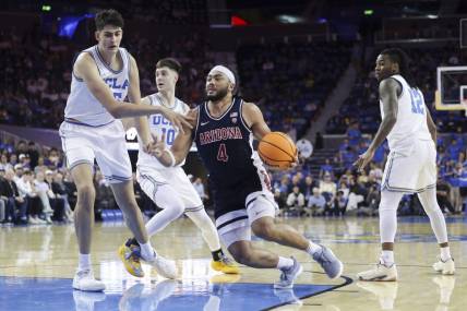 Mar 7, 2024; Los Angeles, California, USA; Arizona Wildcats guard Kylan Boswell (4) drives the ball against UCLA defenders during the first half at Pauley Pavilion presented by Wescom. Mandatory Credit: Yannick Peterhans-USA TODAY Sports