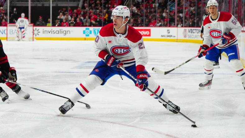 Mar 7, 2024; Raleigh, North Carolina, USA; Montreal Canadiens left wing Juraj Slafkovsky (20) skates with the puck against the Carolina Hurricanes during the second period at PNC Arena. Mandatory Credit: James Guillory-USA TODAY Sports