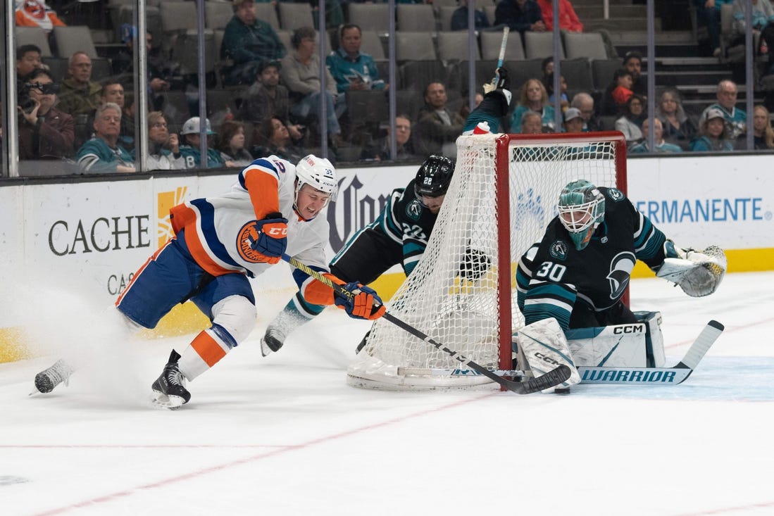 Mar 7, 2024; San Jose, California, USA; New York Islanders center Kyle MacLean (32) attempts to shoot the puck during the first period against San Jose Sharks goaltender Magnus Chrona (30) at SAP Center at San Jose. Mandatory Credit: Stan Szeto-USA TODAY Sports