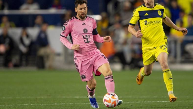 Mar 7, 2024; Nashville, TN, USA; Inter Miami forward Lionel Messi (10) dribbles against the Nashville SC during the second half at GEODIS Park. Mandatory Credit: Steve Roberts-USA TODAY Sports