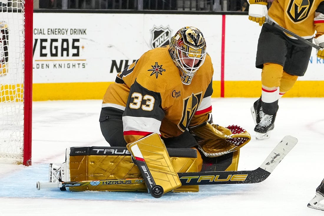 Mar 7, 2024; Las Vegas, Nevada, USA; Vegas Golden Knights goaltender Adin Hill (33) makes as save against the Vancouver Canucks during the third period at T-Mobile Arena. Mandatory Credit: Stephen R. Sylvanie-USA TODAY Sports