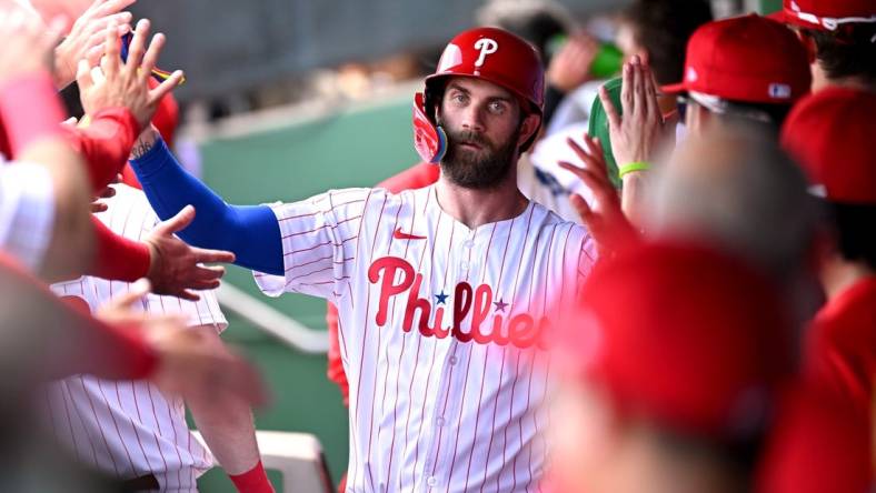 Mar 8, 2024; Clearwater, Florida, USA; Philadelphia Phillies first baseman Bryce Harper (3) celebrates with his teammates after scoring a run in the first inning of the spring training game against the Houston Astros at BayCare Ballpark. Mandatory Credit: Jonathan Dyer-USA TODAY Sports