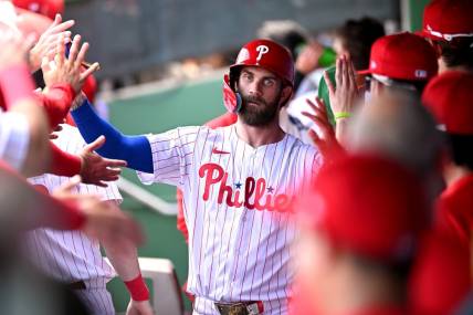Mar 8, 2024; Clearwater, Florida, USA; Philadelphia Phillies first baseman Bryce Harper (3) celebrates with his teammates after scoring a run in the first inning of the spring training game against the Houston Astros at BayCare Ballpark. Mandatory Credit: Jonathan Dyer-USA TODAY Sports