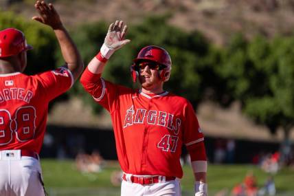 Mar 8, 2024; Tempe, Arizona, USA; Los Angeles Angels infielder Sam Brown (47) celebrates after hitting the go ahead run in the ninth to score outfielder Jordyn Adams (39) (not shown) in the ninth during a spring training game against the Colorado Rockies at Tempe Diablo Stadium. Mandatory Credit: Allan Henry-USA TODAY Sports
