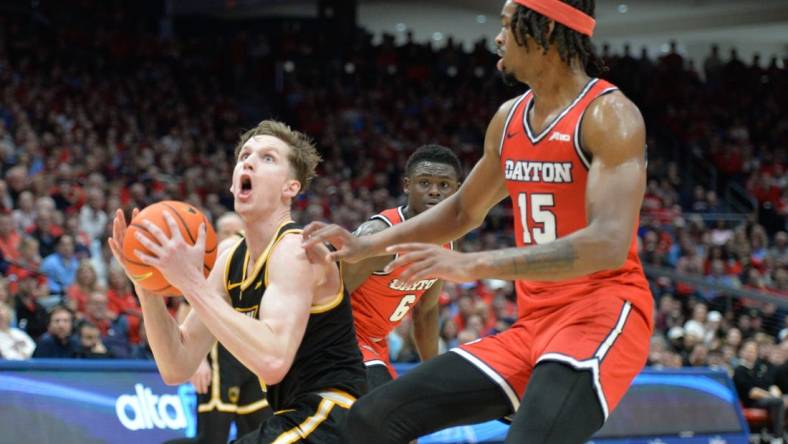 Mar 8, 2024; Dayton, Ohio, USA; Virginia Commonwealth Rams guard Sean Bairstow (7) shoots the ball against Dayton Flyers forward DaRon Holmes II (15) during the first half of the game at University of Dayton Arena. Mandatory Credit: Matt Lunsford-USA TODAY Sports