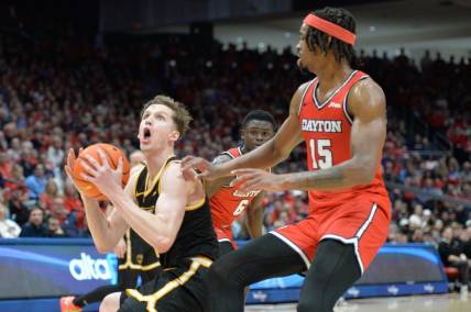 Mar 8, 2024; Dayton, Ohio, USA; Virginia Commonwealth Rams guard Sean Bairstow (7) shoots the ball against Dayton Flyers forward DaRon Holmes II (15) during the first half of the game at University of Dayton Arena. Mandatory Credit: Matt Lunsford-USA TODAY Sports