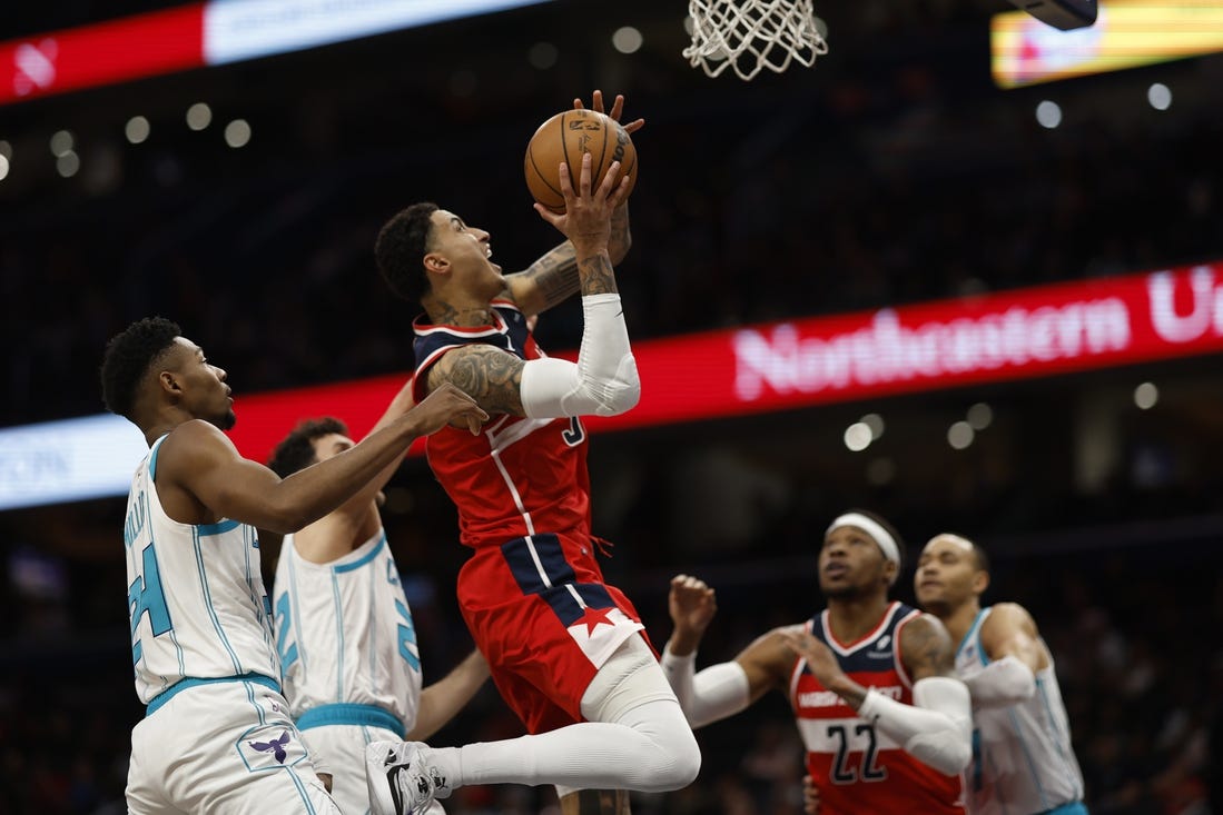 Mar 8, 2024; Washington, District of Columbia, USA;  Washington Wizards forward Kyle Kuzma (33) shoots the ball while being fouled by Charlotte Hornets forward Brandon Miller (24) in the first halfat Capital One Arena. Mandatory Credit: Geoff Burke-USA TODAY Sports