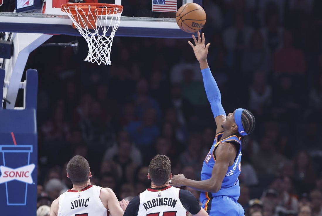 Mar 8, 2024; Oklahoma City, Oklahoma, USA; Oklahoma City Thunder guard Shai Gilgeous-Alexander (2) lays up a shot in front of Miami Heat forward Duncan Robinson (55) during the first quarter at Paycom Center. Mandatory Credit: Alonzo Adams-USA TODAY Sports