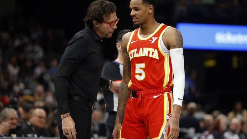 Mar 8, 2024; Memphis, Tennessee, USA; Atlanta Hawks head coach Quin Snyder (left) talks with Atlanta Hawks guard Dejounte Murray (5) during the first half against the Memphis Grizzlies at FedExForum. Mandatory Credit: Petre Thomas-USA TODAY Sports