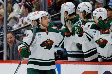 Mar 8, 2024; Denver, Colorado, USA; Minnesota Wild defenseman Brock Faber (7) celebrates with the bench after his goal in the second period against the Colorado Avalanche at Ball Arena. Mandatory Credit: Isaiah J. Downing-USA TODAY Sports