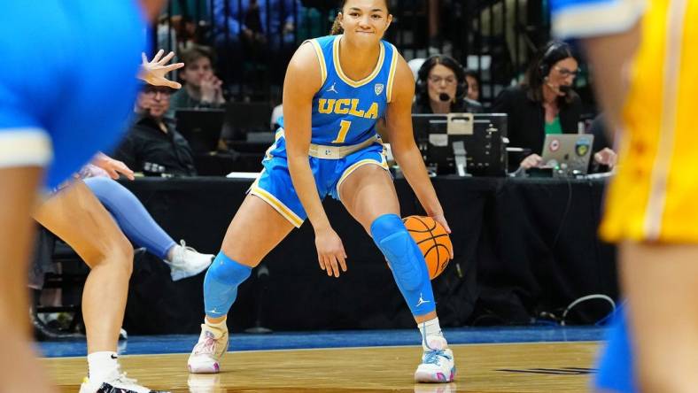 Mar 8, 2024; Las Vegas, NV, USA; UCLA Bruins guard Kiki Rice (1) dribbles against the USC Trojans during the first quarter at MGM Grand Garden Arena. Mandatory Credit: Stephen R. Sylvanie-USA TODAY Sports