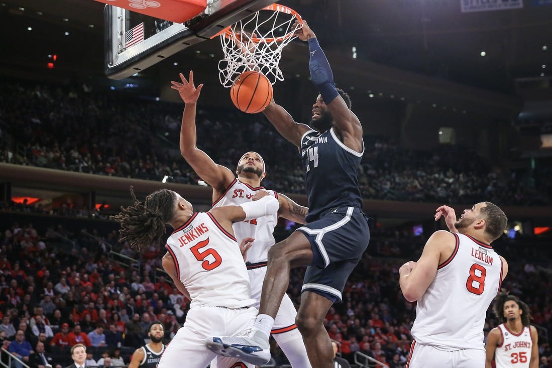 Mar 9, 2024; New York, New York, USA;  Georgetown Hoyas forward Supreme Cook (24) dunks past St. John's Red Storm guard Daniss Jenkins (5) in the first half at Madison Square Garden. Mandatory Credit: Wendell Cruz-USA TODAY Sports
