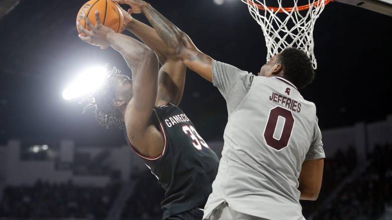 Mar 9, 2024; Starkville, Mississippi, USA; South Carolina Gamecocks forward Josh Gray (33) shoots as Mississippi State Bulldogs forward D.J. Jeffries (0) defends during the first half at Humphrey Coliseum. Mandatory Credit: Petre Thomas-USA TODAY Sports