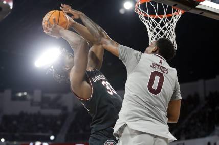 Mar 9, 2024; Starkville, Mississippi, USA; South Carolina Gamecocks forward Josh Gray (33) shoots as Mississippi State Bulldogs forward D.J. Jeffries (0) defends during the first half at Humphrey Coliseum. Mandatory Credit: Petre Thomas-USA TODAY Sports