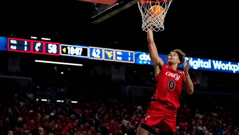 Cincinnati Bearcats guard Dan Skillings Jr. (0) goes up for an open dunk in the second half of the NCAA basketball game between Cincinnati Bearcats and West Virginia Mountaineers at Fifth Third Arena in Cincinnati on Saturday, March 9, 2024.