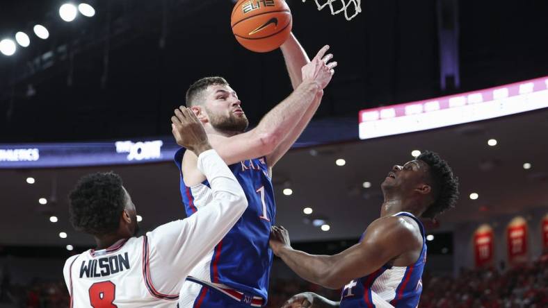 Mar 9, 2024; Houston, Texas, USA; Kansas Jayhawks center Hunter Dickinson (1) attempts to score as Houston Cougars guard Mylik Wilson (8) defends during the first half at Fertitta Center. Mandatory Credit: Troy Taormina-USA TODAY Sports