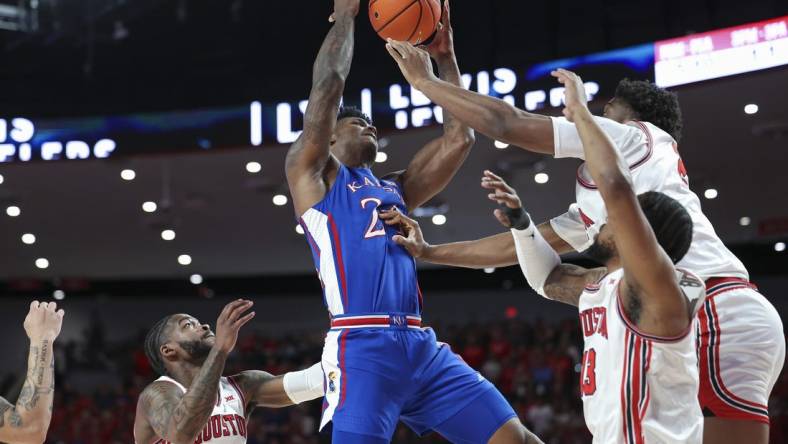 Mar 9, 2024; Houston, Texas, USA; Kansas Jayhawks forward K.J. Adams Jr. (24) attempts to control the ball as Houston Cougars center Cedric Lath (2) defends during the first half at Fertitta Center. Mandatory Credit: Troy Taormina-USA TODAY Sports