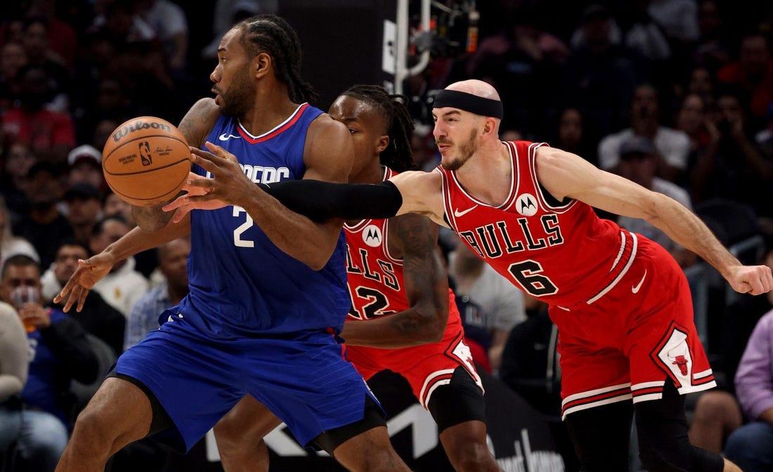 Mar 9, 2024; Los Angeles, California, USA; Chicago Bulls guard Alex Caruso (6) knocks the ball away from LA Clippers forward Kawhi Leonard (2) during the second quarter at Crypto.com Arena. Mandatory Credit: Jason Parkhurst-USA TODAY Sports