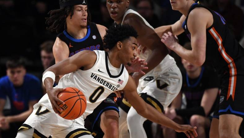 Mar 9, 2024; Nashville, Tennessee, USA; Vanderbilt Commodores guard Tyrin Lawrence (0) drives to the basket against Florida Gators guard Walter Clayton Jr. (1) during the first half at Memorial Gymnasium. Mandatory Credit: Christopher Hanewinckel-USA TODAY Sports