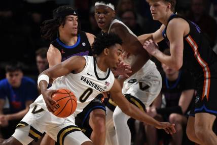 Mar 9, 2024; Nashville, Tennessee, USA; Vanderbilt Commodores guard Tyrin Lawrence (0) drives to the basket against Florida Gators guard Walter Clayton Jr. (1) during the first half at Memorial Gymnasium. Mandatory Credit: Christopher Hanewinckel-USA TODAY Sports