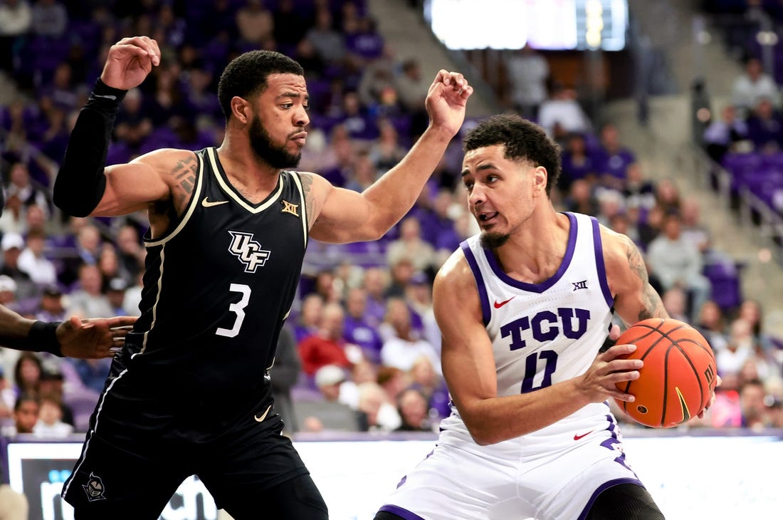 Mar 9, 2024; Fort Worth, Texas, USA;  TCU Horned Frogs guard Micah Peavy (0) controls the ball as UCF Knights guard Darius Johnson (3) defends during the first half at Ed and Rae Schollmaier Arena. Mandatory Credit: Kevin Jairaj-USA TODAY Sports