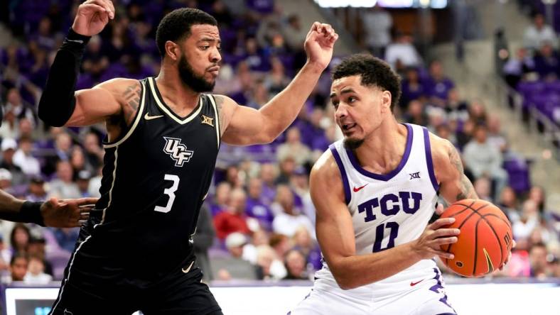 Mar 9, 2024; Fort Worth, Texas, USA;  TCU Horned Frogs guard Micah Peavy (0) controls the ball as UCF Knights guard Darius Johnson (3) defends during the first half at Ed and Rae Schollmaier Arena. Mandatory Credit: Kevin Jairaj-USA TODAY Sports