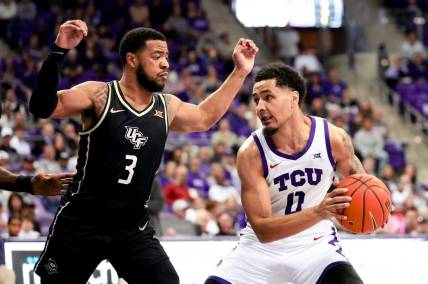 Mar 9, 2024; Fort Worth, Texas, USA;  TCU Horned Frogs guard Micah Peavy (0) controls the ball as UCF Knights guard Darius Johnson (3) defends during the first half at Ed and Rae Schollmaier Arena. Mandatory Credit: Kevin Jairaj-USA TODAY Sports