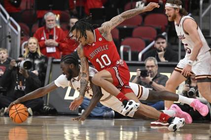 Mar 9, 2024; Louisville, Kentucky, USA;  Boston College Eagles guard Prince Aligbe (10) dives for the ball with Louisville Cardinals forward Kaleb Glenn (10) during the first half at KFC Yum! Center. Mandatory Credit: Jamie Rhodes-USA TODAY Sports