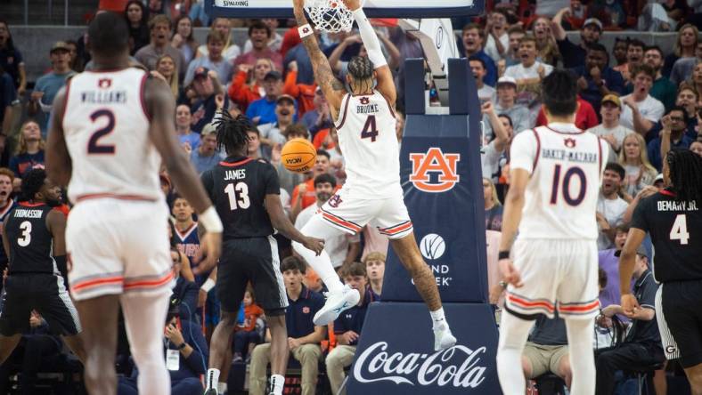 Auburn Tigers forward Johni Broome (4) dunks the ball as Auburn Tigers take on Georgia Bulldogs at Neville Arena in Auburn, Ala., on Saturday, March 9, 2024.