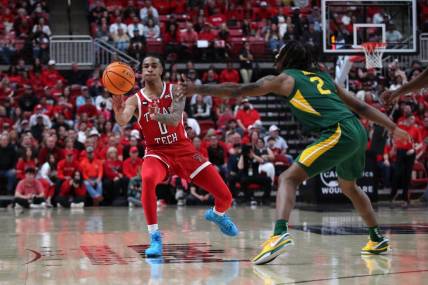 Mar 9, 2024; Lubbock, Texas, USA; Texas Tech Red Raiders guard Chance McMillian (0) passes the ball against Baylor Bears guard Jayden Nunn (2) in the first half at United Supermarkets Arena. Mandatory Credit: Michael C. Johnson-USA TODAY Sports
