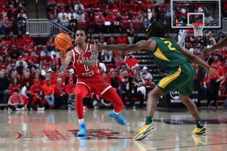 Mar 9, 2024; Lubbock, Texas, USA; Texas Tech Red Raiders guard Chance McMillian (0) passes the ball against Baylor Bears guard Jayden Nunn (2) in the first half at United Supermarkets Arena. Mandatory Credit: Michael C. Johnson-USA TODAY Sports